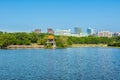 Lake, island,  green forest and Chinese traditional pavilion against blue sky in longtan Park, Longgang, Shenzhen, China Royalty Free Stock Photo