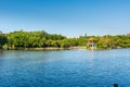 Lake, island,  green forest and Chinese traditional pavilion against blue sky in longtan Park, Longgang, Shenzhen, China Royalty Free Stock Photo