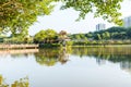 Lake, island,  green forest and Chinese traditional pavilion against blue sky in longtan Park, Longgang, Shenzhen, China Royalty Free Stock Photo