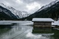 Lake Jagersee in winter with snow and wooden hut. Royalty Free Stock Photo