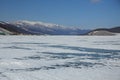 Lake Khubsugul is covered with ice and snow strong cold thick clear blue ice. Lake Khubsugul is a frosty winter day. Amazing