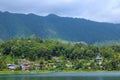 Lake landscape blue water, hill view from the top. Clear sky with green wood. Large panorama while travelling Royalty Free Stock Photo