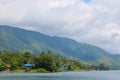 Lake landscape blue water, hill view from the top. Clear sky with green wood. Large panorama while travelling Royalty Free Stock Photo