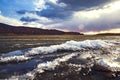 Lake landscape with bright sunshine over mountains Royalty Free Stock Photo