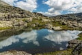 Lake landscape with clouds reflection, rocky mountain tundra, Norway