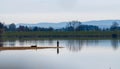 Lake landscape with fisherman on pennisula