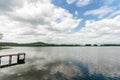 lake landscape with wood dock in a cloudy day Royalty Free Stock Photo