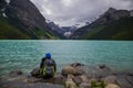 Lake Louise, Banff National Park, Alberta, Canada. Backpack hiker looks on amazing landscape. Active life.