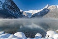 Lake Louise in early winter sunny day morning. Mist floating on turquoise color water surface. Royalty Free Stock Photo