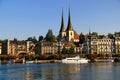 Lake Lucerne waterfront with historic buildings and tourist boat in the foreground