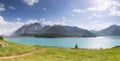 Lake and meadow by the mountains in the French Alps Royalty Free Stock Photo