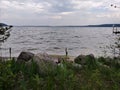 Rocks Lake trees pebbles waves water sky clouds vegetation beach evening view scenic