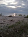 Sunset Rocks Lake trees pebbles waves water sky clouds vegetation beach evening view scenic