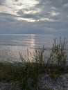 Sunset Rocks Lake trees pebbles waves water sky clouds vegetation beach evening view scenic