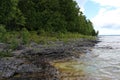 Lake Michigan`s rocky and tree lined shoreline at Cave Point County Park in Door County, Wisconsin Royalty Free Stock Photo