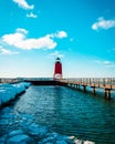 Charlevoix, MI /USA - March 3rd 2018: Lake Michigan thawing out at the South Pier lighthouse in Charlevoix MI during the winter