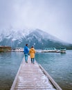 Lake Minnewanka Banff national park Canada, couple walking by the lake during snow storm in October in the Canadian Royalty Free Stock Photo