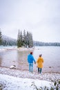 Lake Minnewanka Banff national park Canada, couple walking by the lake during snow storm in October in the Canadian Royalty Free Stock Photo