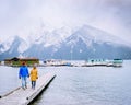 Lake Minnewanka Banff national park Canada, couple walking by the lake during snow storm in October in the Canadian Royalty Free Stock Photo