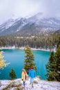 Lake Minnewanka Banff national park Canada, couple walking by the lake during snow storm in October in the Canadian Royalty Free Stock Photo