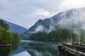 lake and misty forest in mountains in a rainy day Royalty Free Stock Photo