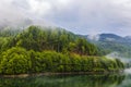 Lake and misty forest in mountains in a rainy day Royalty Free Stock Photo