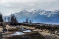 A Lake with Mountain Range Reflected in the Partially Frozen Waters of a Lake in the Great Alaskan Wilderness.