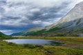 Lake between mountains in the background of the storm sky