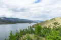 Lake, mountains, clouds, summer. A picturesque panoramic landscape over the lake, shot day after day with clouds in the sky. Royalty Free Stock Photo