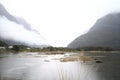 Lake and mountains covered in clouds. Milford Sound, New Zealand. Royalty Free Stock Photo