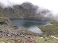 Lake between mountains with fog at top