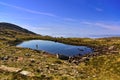 Lake in the mountains with hiker, Applecross, Wester Ross, Scotland