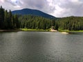 Lake in the mountains. Lake near the forest. Coniferous forest. Forest. Summer day near the lake. Autumn