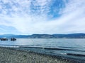 Lake shore and beach with boat on dock