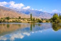 Lake in the mountains. Quiet bay in the greenery at sunset. Place for rest. Kyrgyzstan Royalty Free Stock Photo