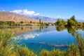 Lake in the mountains. Quiet bay in the greenery at sunset. Place for rest. Kyrgyzstan Royalty Free Stock Photo