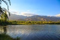 Lake in the mountains. Quiet bay in the greenery at sunset. Place for rest. Kyrgyzstan, Lake Issyk-Kul Royalty Free Stock Photo