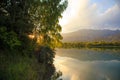 Lake in the mountains. Quiet bay in the greenery at sunset. Place for rest. Kyrgyzstan, Lake Issyk-Kul Royalty Free Stock Photo