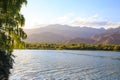 Lake in the mountains. Quiet bay in the greenery at sunset. Place for rest. Kyrgyzstan, Lake Issyk-Kul Royalty Free Stock Photo