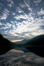 Lake in the mountains in reflection of the dawn sky Royalty Free Stock Photo