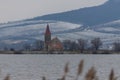 Lake Musov with the Church of St. Linharta in the Czech Republic in Europe. There is a reed around. Winter landscape and Palava