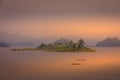 Lake Mutanda at sunset with view on the volcanoes mount Muhavuru and mount Gahinga in East Africa, along the border of Rwanda and