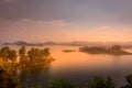 Lake Mutanda at sunset with view on the volcanoes mount Muhavuru and mount Gahinga in East Africa, along the border of Rwanda and