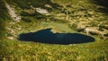 Lake Nesamovite and surrounding landscape against background of green mountains Royalty Free Stock Photo