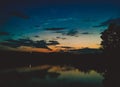 Lake at night reflecting shiny moon on water surface Royalty Free Stock Photo