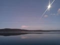 Lake at night reflecting shiny moon on water surface Royalty Free Stock Photo