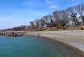 Lake Ontario waterfront in Toronto, with beach with large trees and residential neighborhood