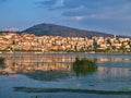 Lake Orestiada and Kastoria city, Greece at sunset time, beautiful light, buildings mirroring on lake water