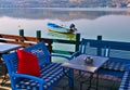 Lake Orestiada, Kastoria, Greece, cafe table on waterfront and boat on calm water