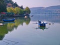 Lake Orestiada, Kastoria Greece. Reflections of boat, land and houses on calm water